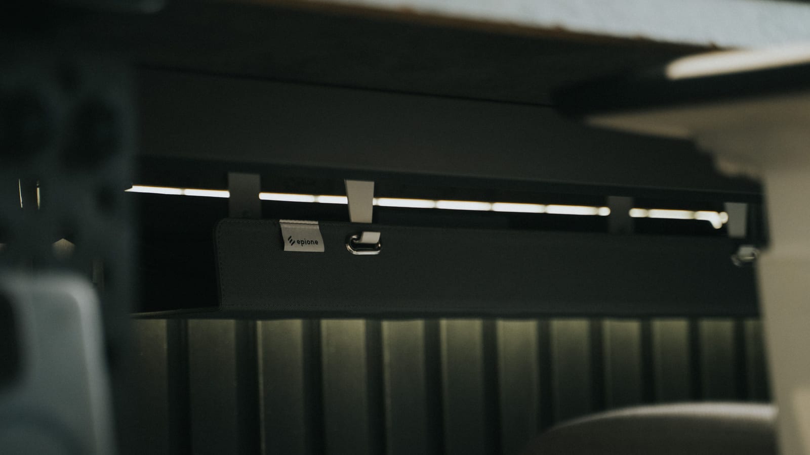 Close-up view of sleek under desk cable management in an office setting, enhancing workspace organization.