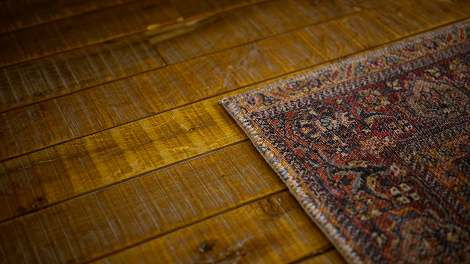 a close up of a rug on a wooden floor